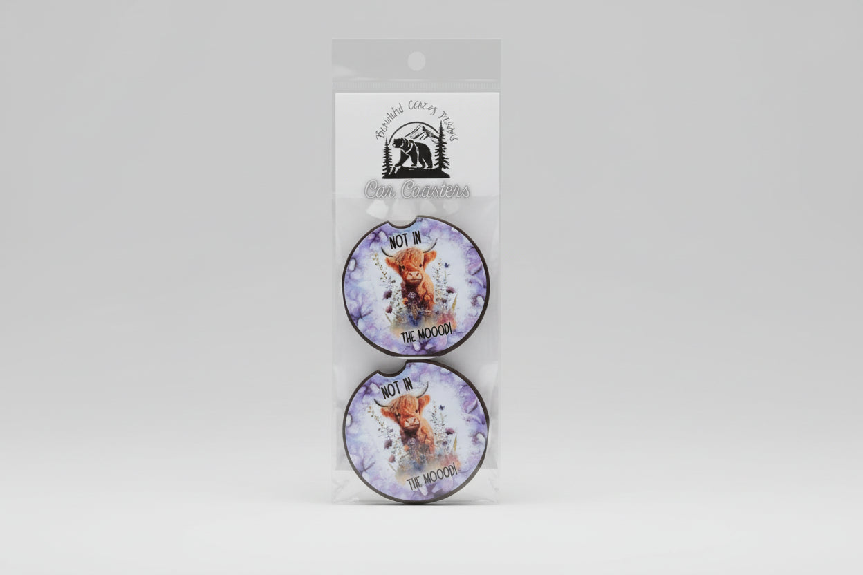 Two round coasters with a cow illustration and text 'Not in the moo!'.