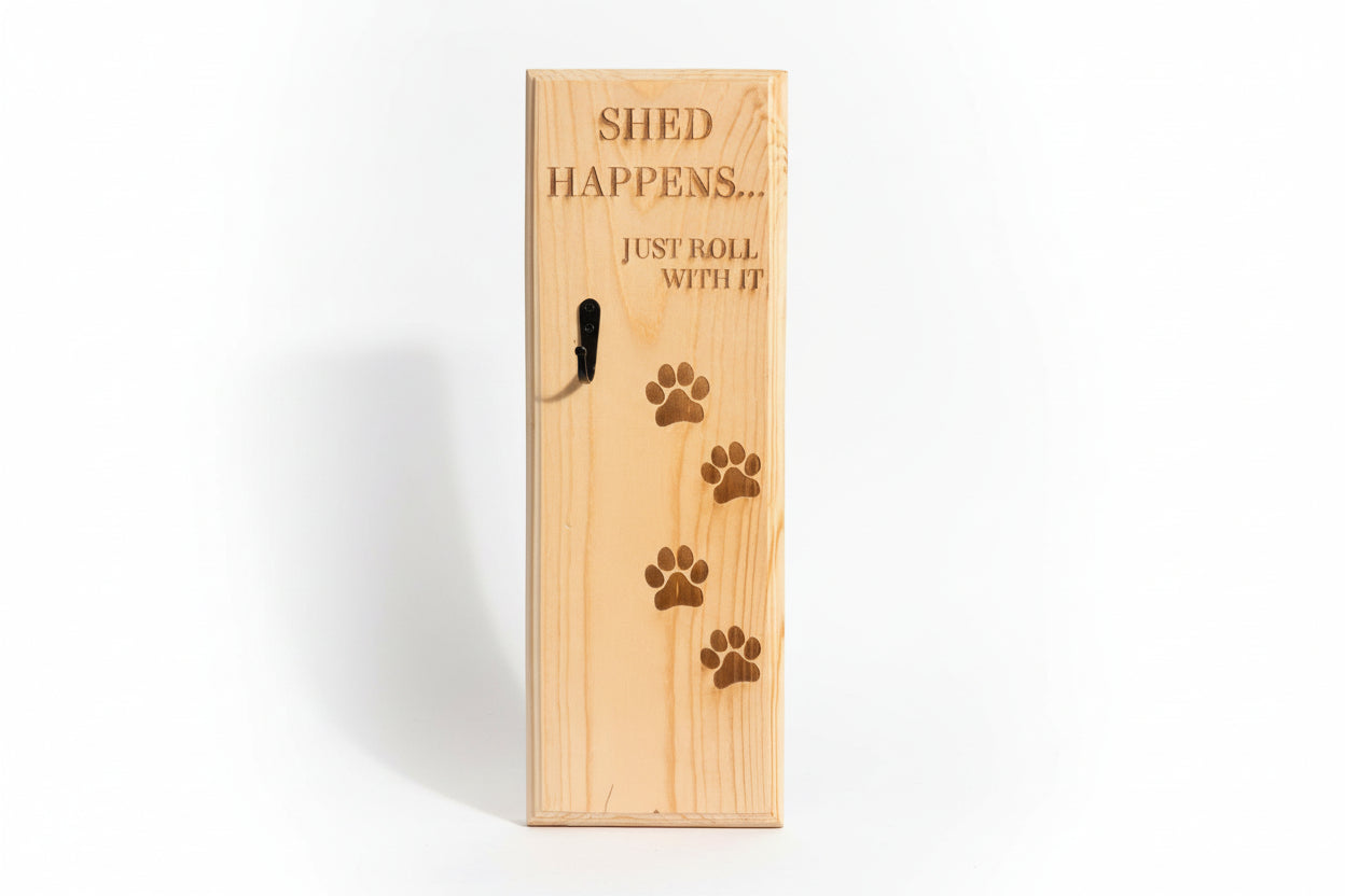 Wooden pet shed box with engraved text and paw prints on a surface.