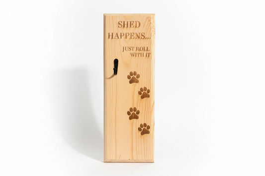 Wooden pet shed box with engraved text and paw prints on a surface.
