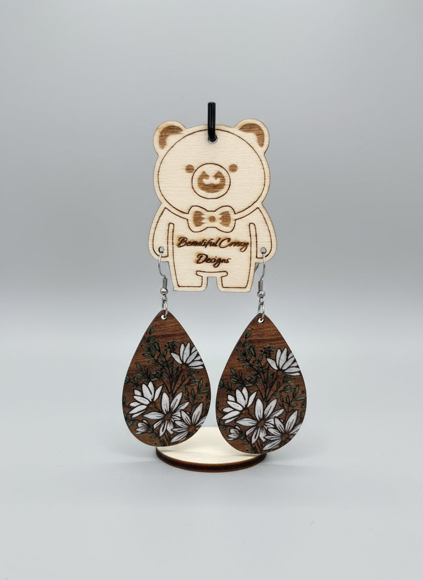 Wooden keychain with floral design on a wooden surface