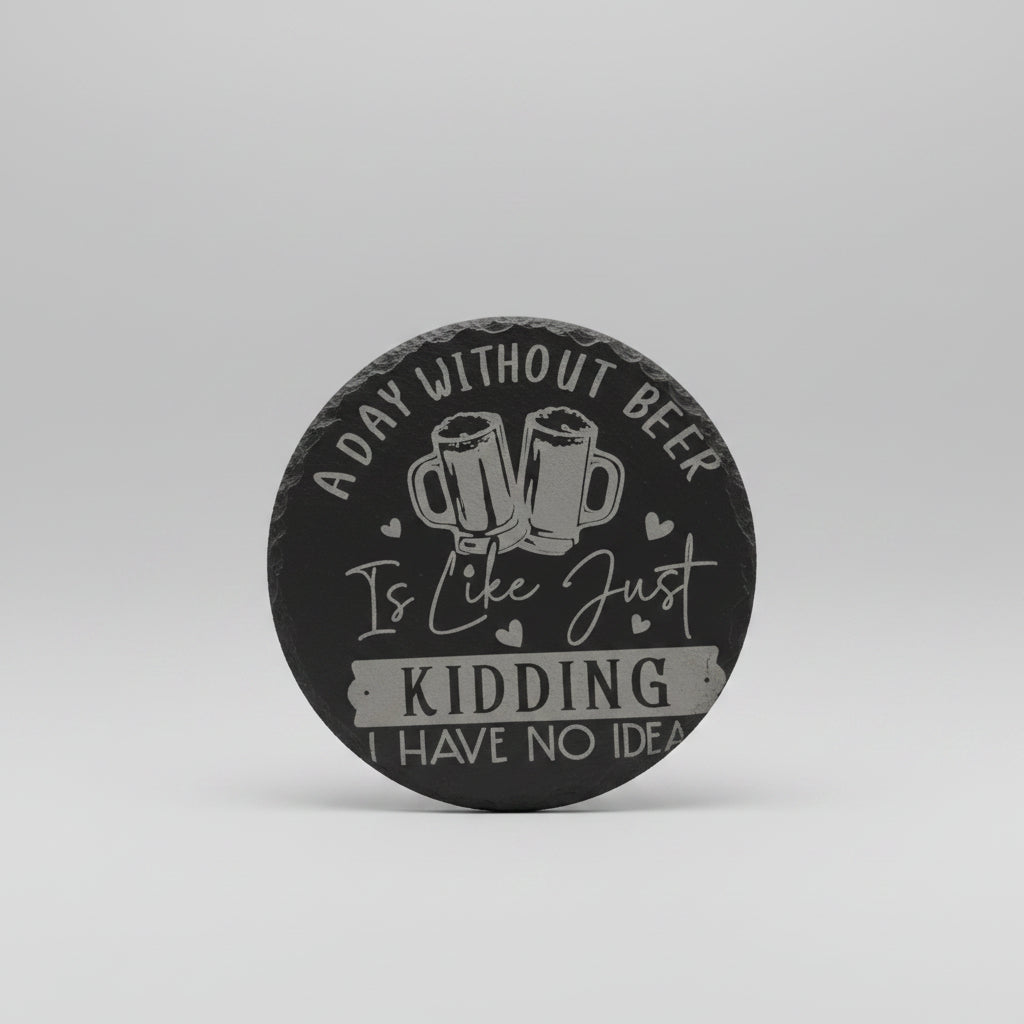 Round black coaster with white text and beer mugs design on a wooden surface.