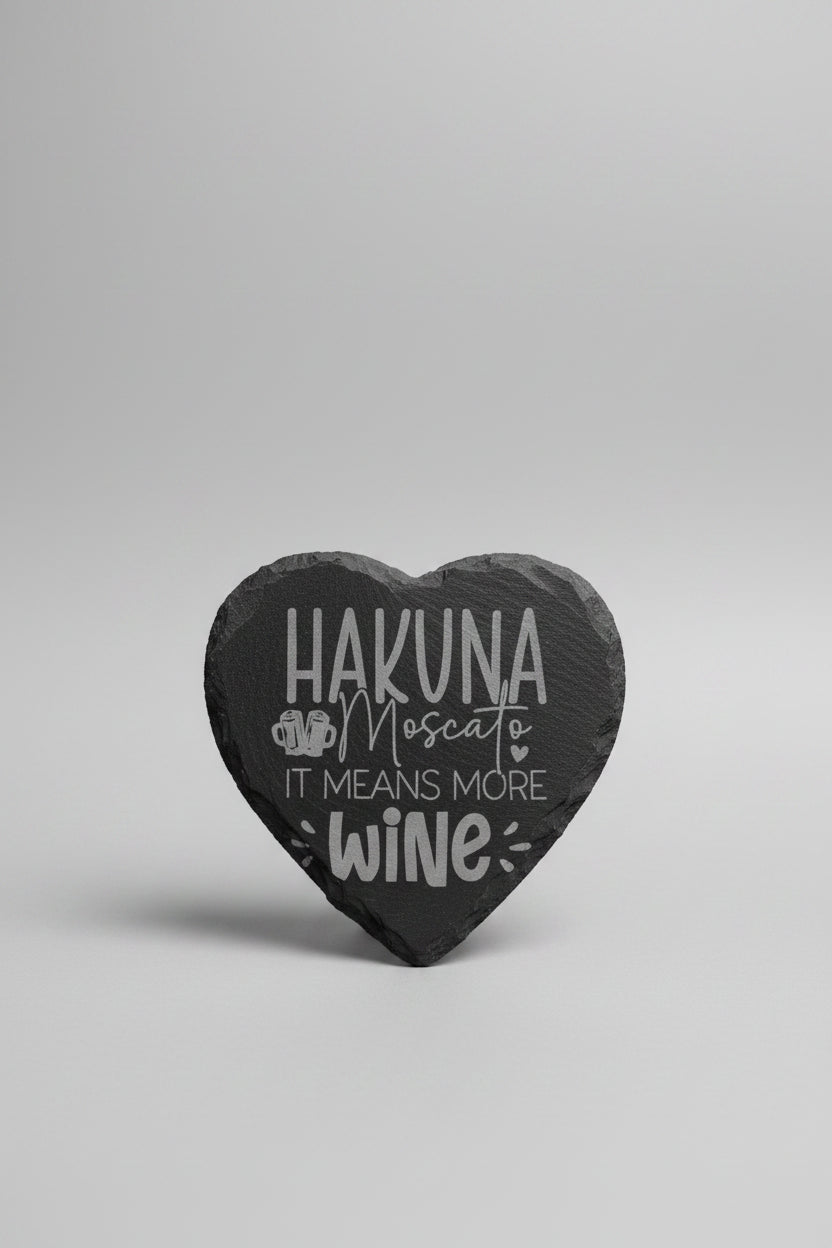 Heart-shaped slate with 'Hakuna Moscato means more wine' text on a neutral background