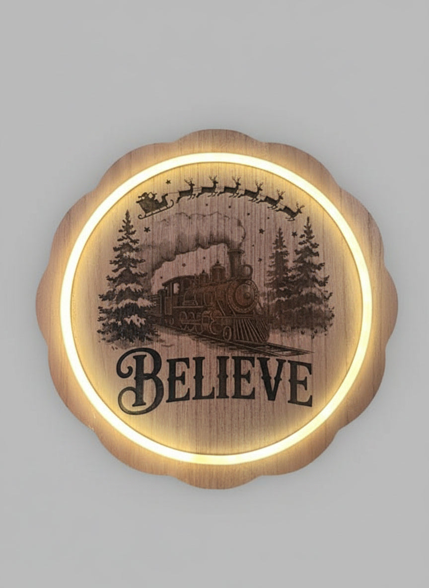Decorative wall art with a train and 'BELIEVE' text on a grey background.