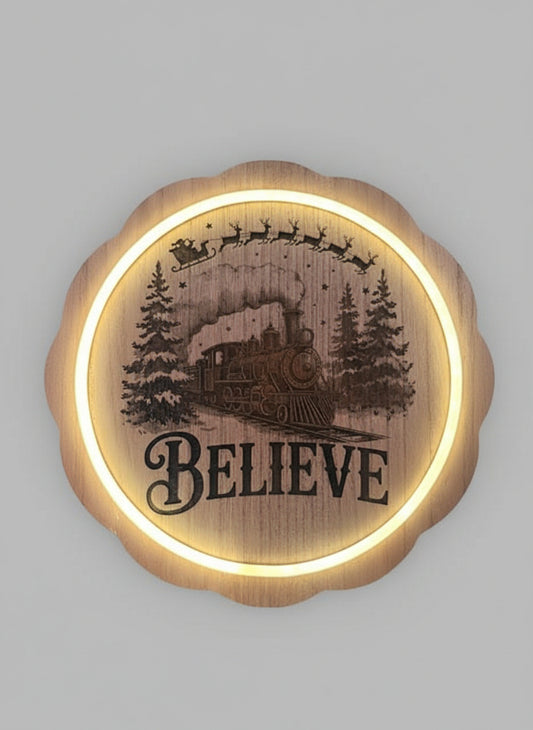 Decorative wall art with a train and 'BELIEVE' text on a grey background.