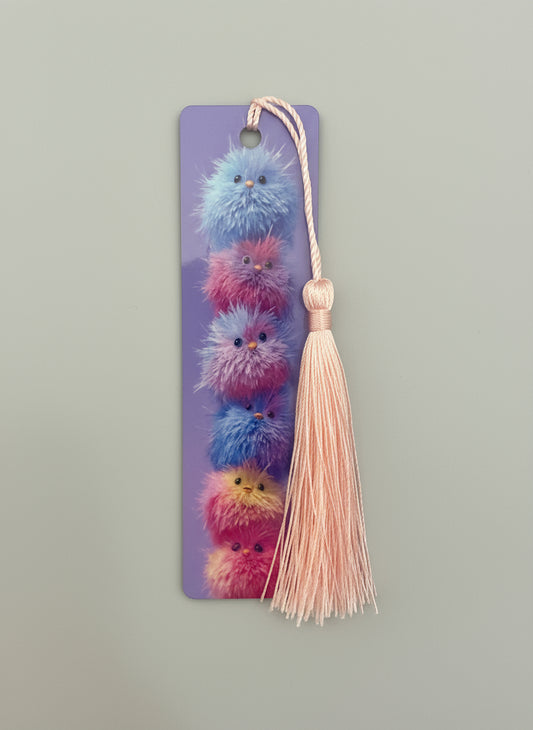 Colorful, fluffy baby chicks bookmark with a tassel on a gray background