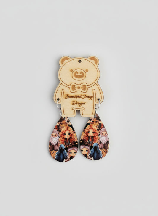 Teardrop-shaped earrings with character design on a black background