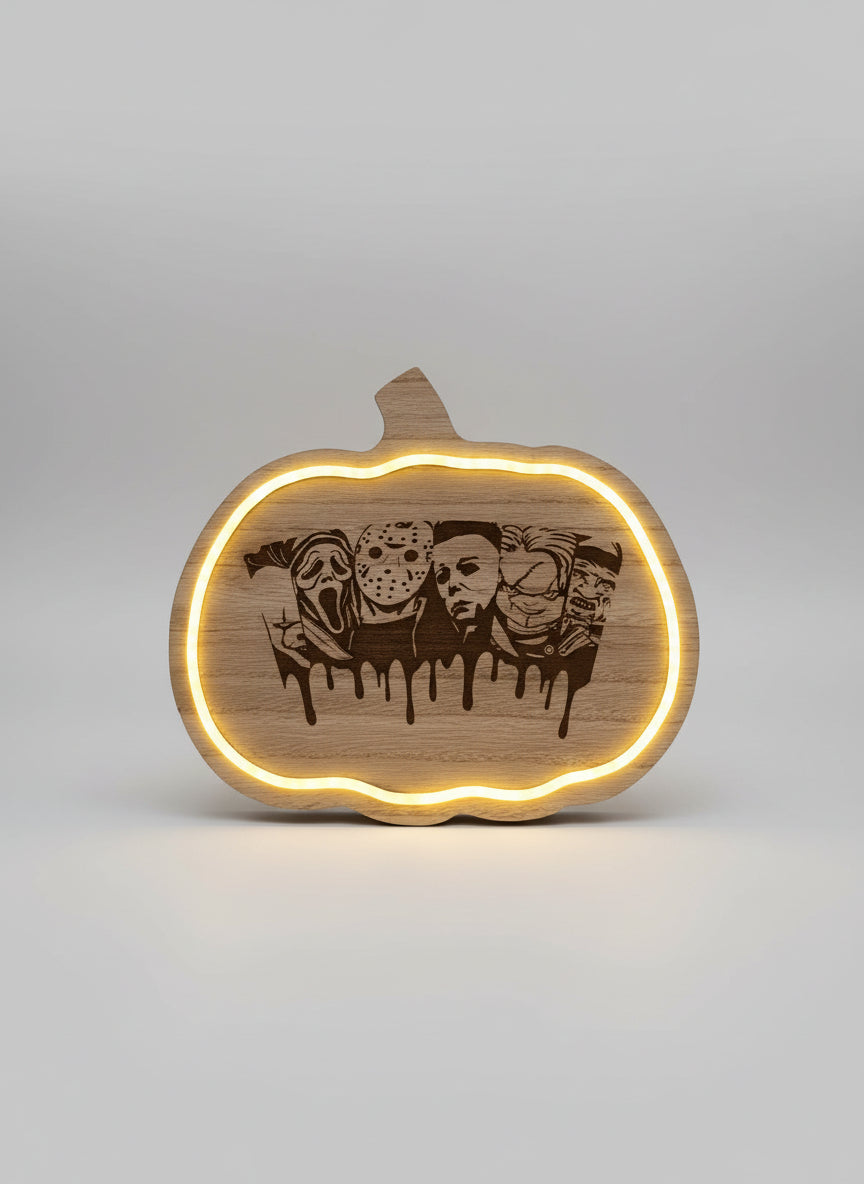 Wooden pumpkin-shaped sign with engraved faces and LED lighting on a dark background