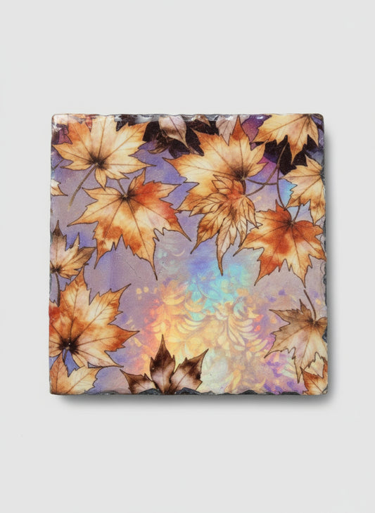 Floral-patterned slate coaster with autumn leaves on a white background