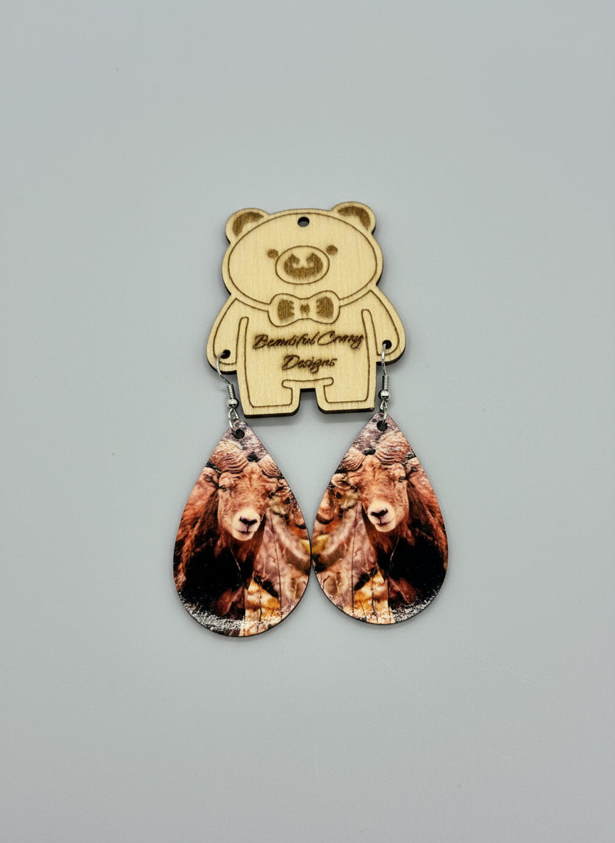 Bear-shaped earrings with teardrop design on a gray background