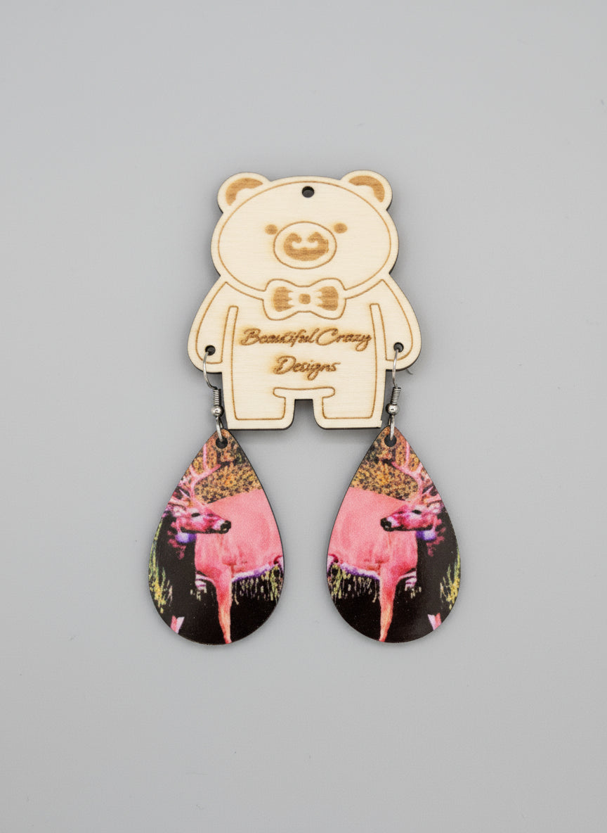 Pair of earrings with a whitetail buck design on a gray background