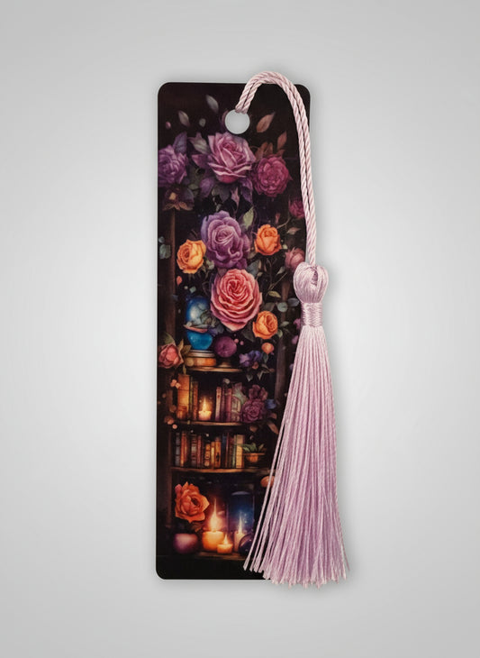 Bookmark with floral design and pink tassel on a light gray background