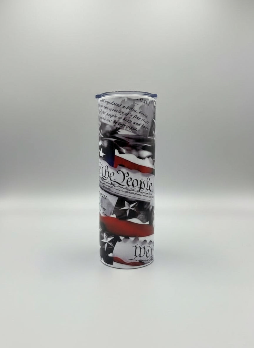 Tumbler with American flag design and text on a grey background.