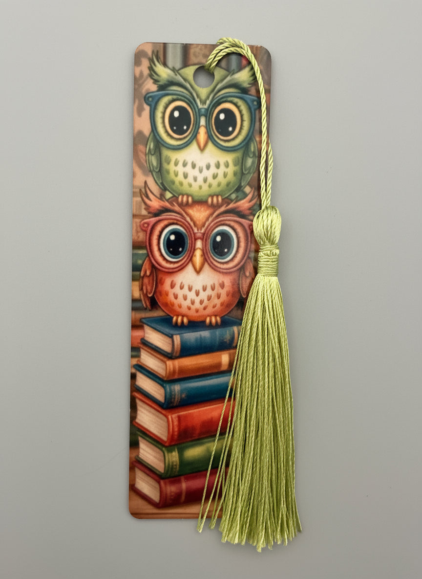 Decorative bookmark with owl design and tassel on a gray background