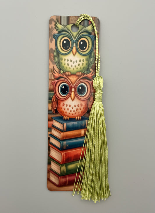 Decorative bookmark with owl design and tassel on a gray background
