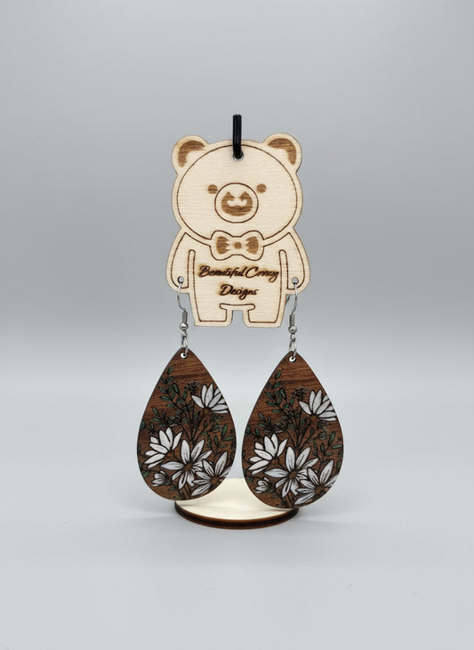 Wooden keychain with floral design on a wooden surface