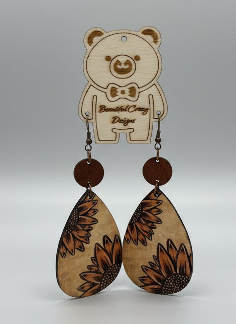Wooden earrings with sunflower design on a white background