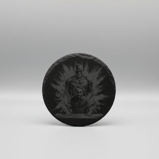 Decorative stone with engraved design of a superhero and two people on a textured wall.