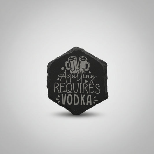 Decorative stone with 'ADULTING REQUIRES VODKA' text on a textured wall background