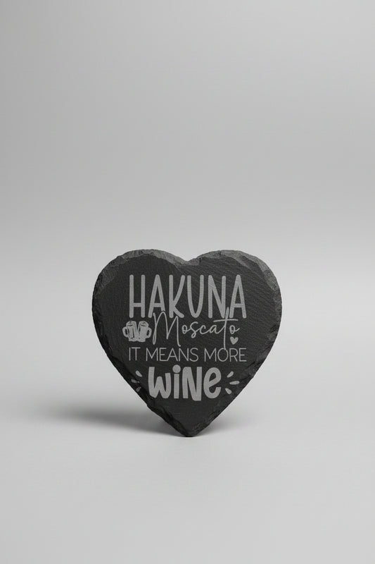Heart-shaped slate with 'Hakuna Moscato means more wine' text on a neutral background